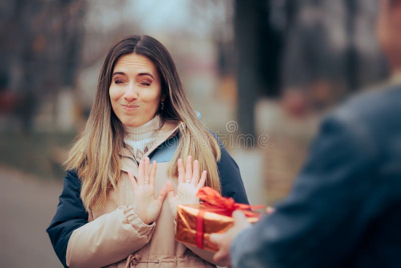 Woman Refusing Politely an Unexpected Gift from Her Admirer Stock Photo