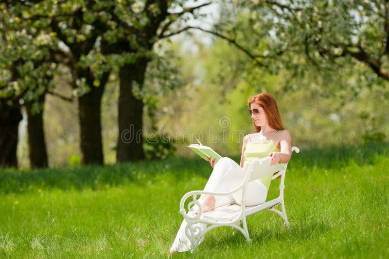 Woman relax under blossom tree in summer