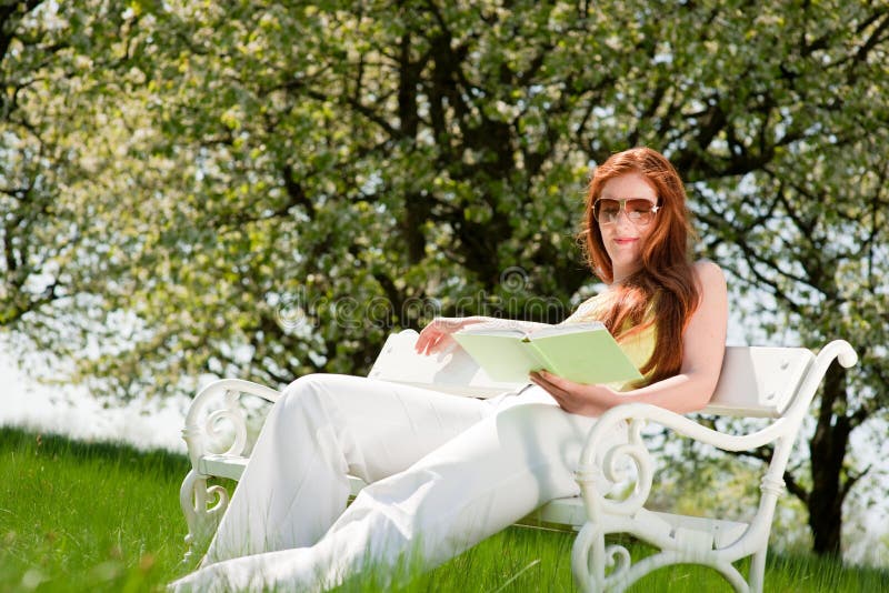 Woman relax under blossom tree in summer