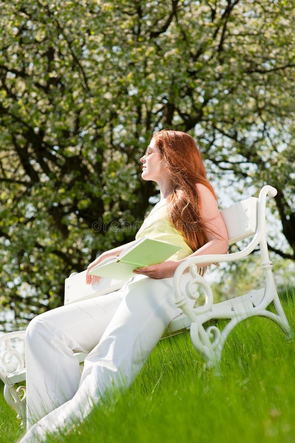 Woman relax under blossom tree in summer