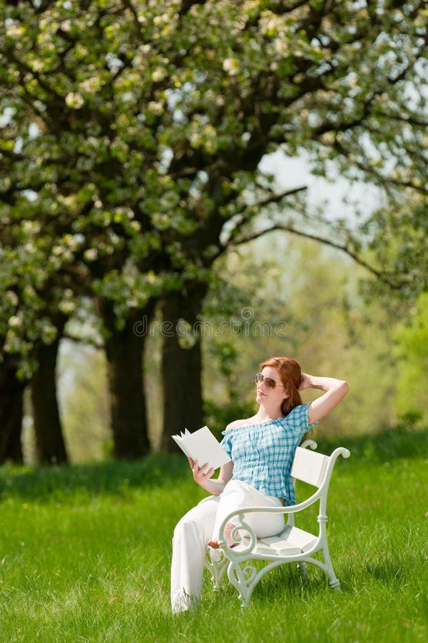 Woman relax under blossom tree in summer