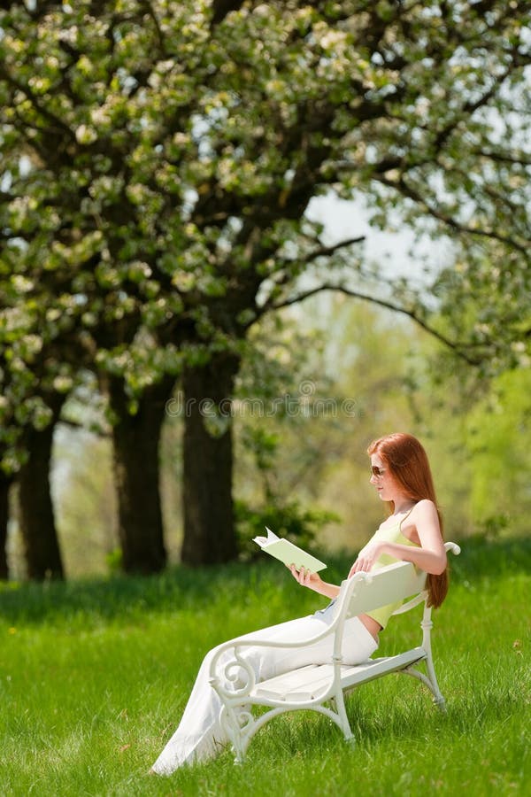 Woman relax under blossom tree in summer