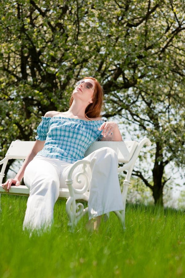 Woman relax under blossom tree in summer