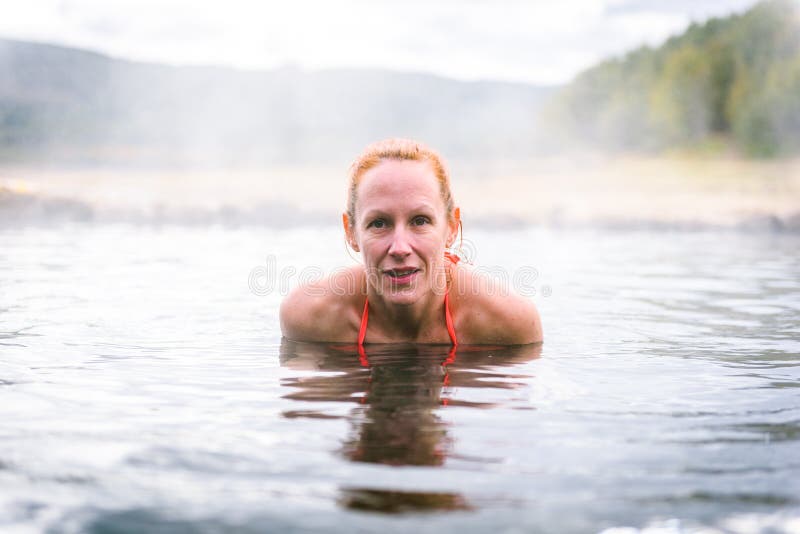 Woman relaxes and enjoys natural hot thermal water roman spa