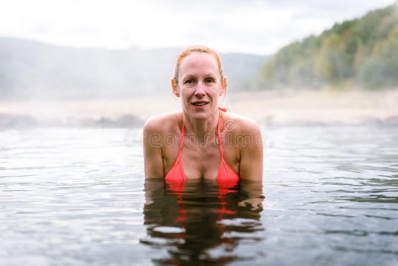 Woman relaxes and enjoys natural hot thermal water roman spa