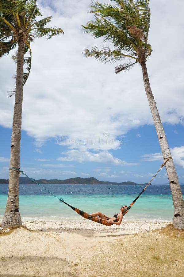 Woman relaxing at the beach on a hammock royalty free stock photos Woman relaxing at the beach on a hammock royalty free stock photos