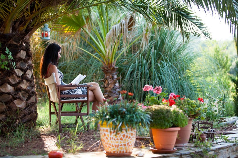 Woman is relaxing in a beautiful garden