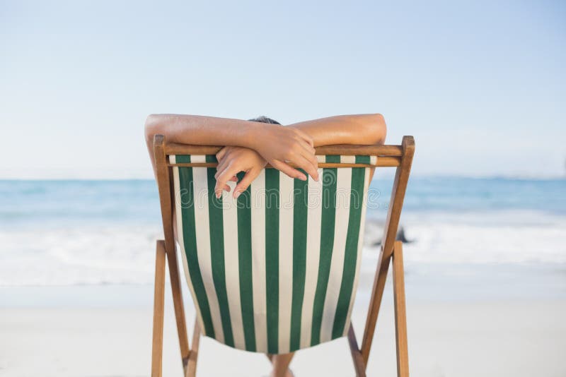 Woman relaxing in deck chair on the beach royalty free stock photo Woman relaxing in deck chair on the beach royalty free stock photo