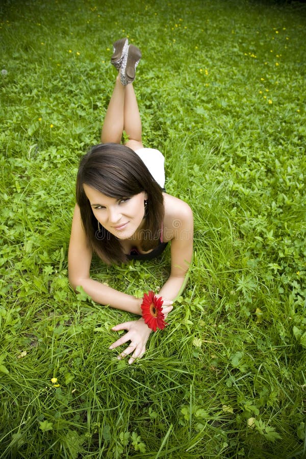Woman relaxing on green grass