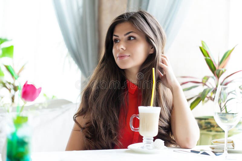 Woman in restaurant is drinking cocktail royalty free stock images