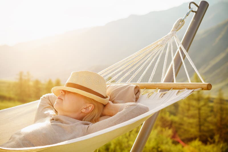 Woman Resting in Hammock Outdoors. Sleeping Outdoors. Stock Photo
