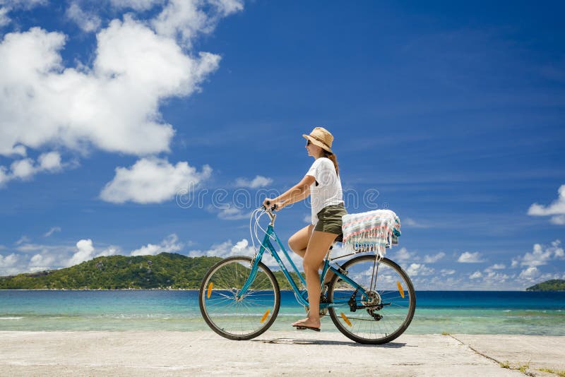 Woman ride along the Beach stock photo. Image of holiday 85093284