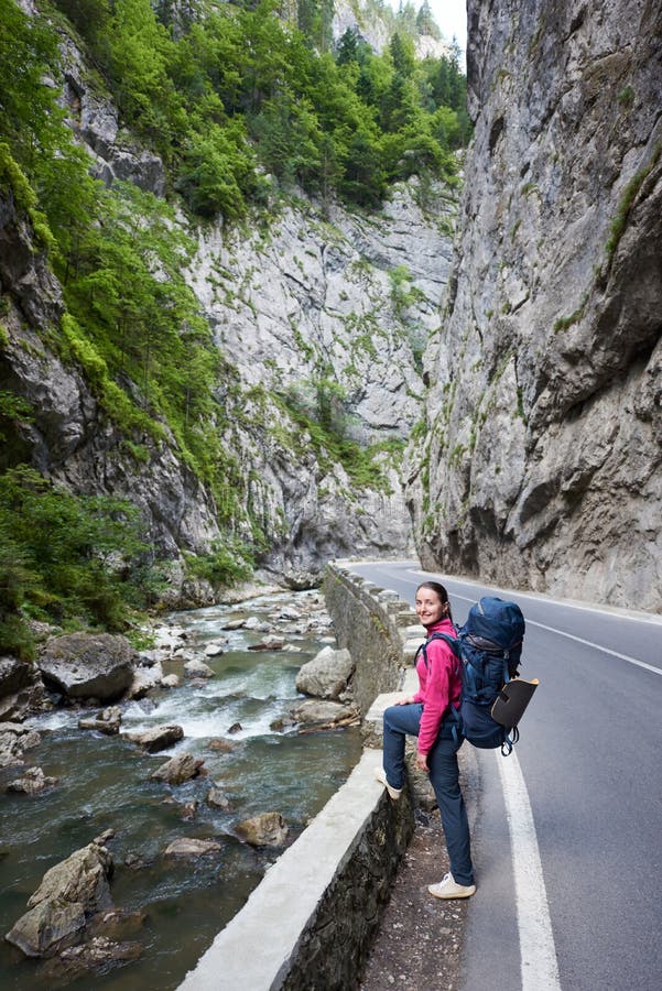 Woman on road next to mountain stream in Bicaz Gorge stock image Woman on road next to mountain stream in Bicaz Gorge stock image