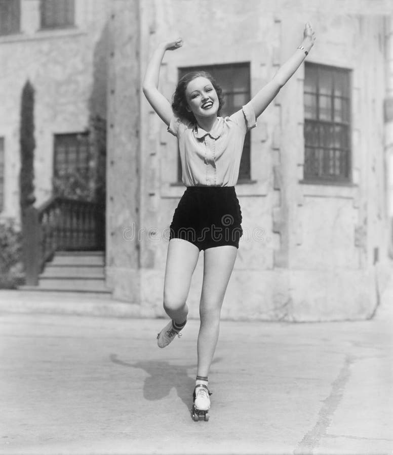 Woman roller-skating on a side walk