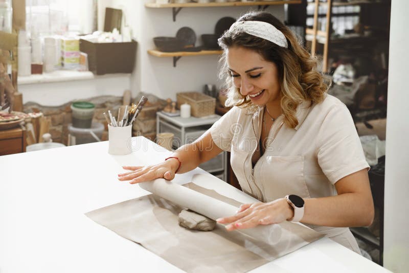 Woman Rolling Clay, Making Ceramic Plate in Studio Stock Photo