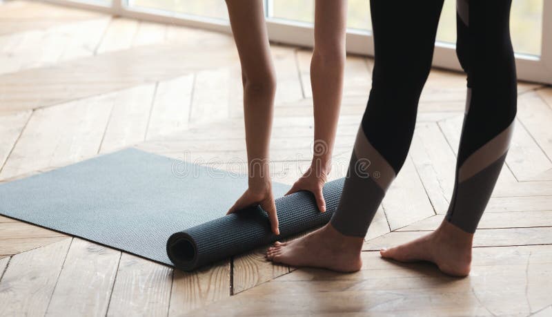 Woman Rolling Yoga Mat, Completing Her Practice Stock Photo - Image of ...