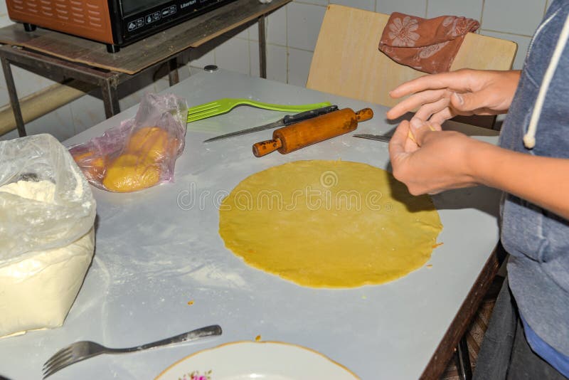 A Woman Rolls the Dough for Making Pita Bread in the Oven Stock Image