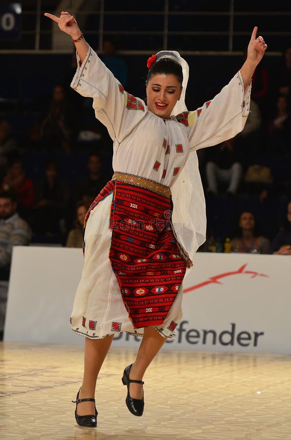 Woman in Romanian national outfit perform during dancesport competition