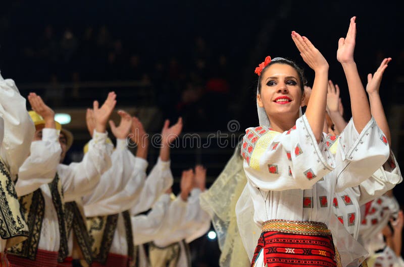 Woman in Romanian traditional outfit perform during dancesport competition