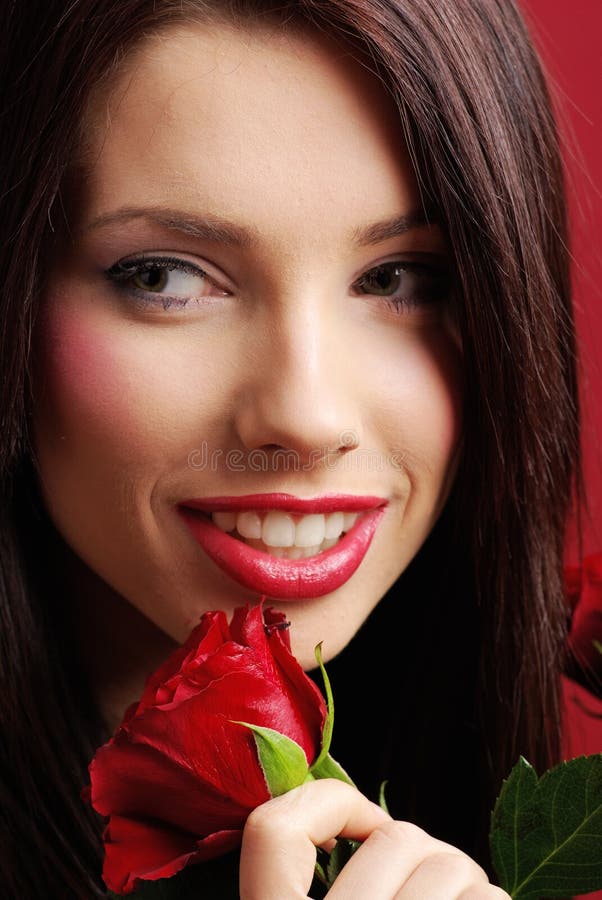 Woman with rose on red background