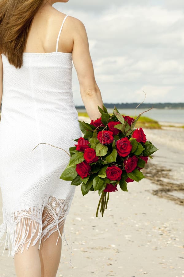 Woman with roses on beach