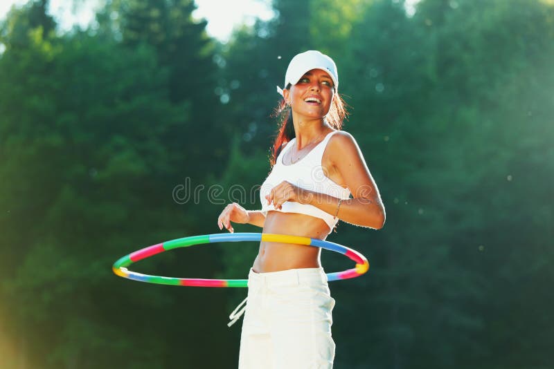 Woman rotates hula hoop