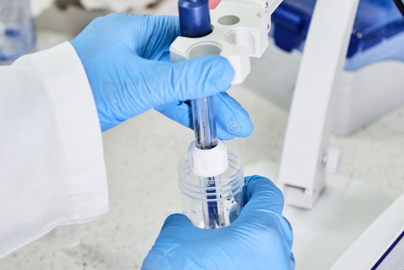 Woman in a Rubber Gloves Holding a Glass Electrode for Measuring of PH