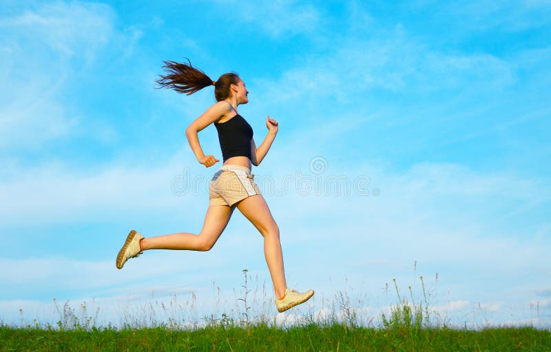 Woman run on green grass