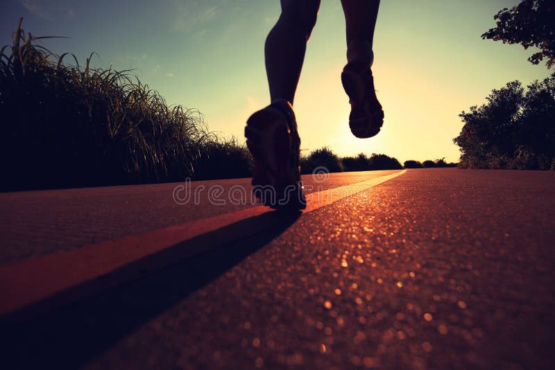 Woman runner running on sunrise seaside