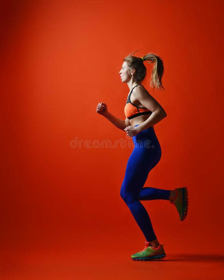 Woman runner in silhouette on red background. Dynamic movement. Side view stock photo Woman runner in silhouette on red background. Dynamic movement. Side view stock photo