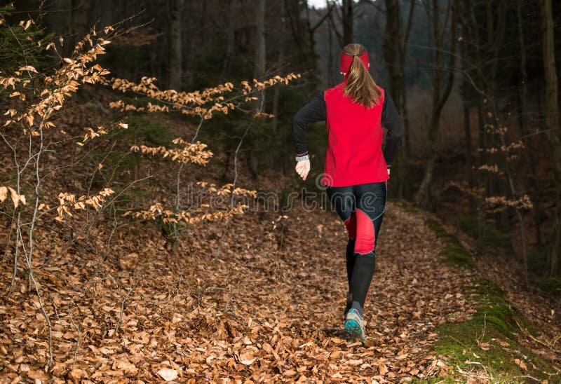 Woman Running on the Autumn Trail in the Dark Forest Stock Image ...