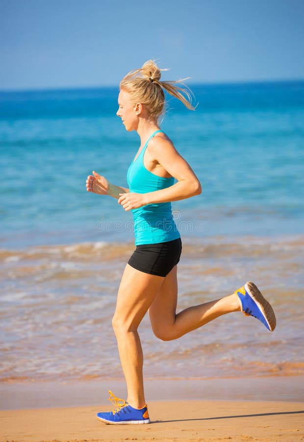 Woman running on the beach stock image. Image of body 37864517