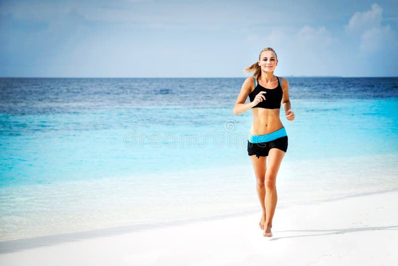 Woman running on the beach stock photos Woman running on the beach stock photos