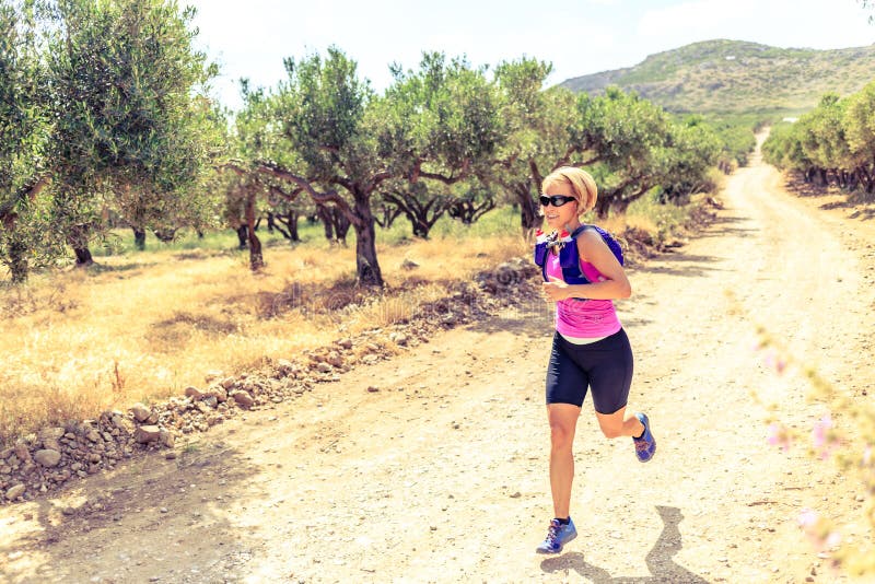 Woman running on path, Crete Island, Greece