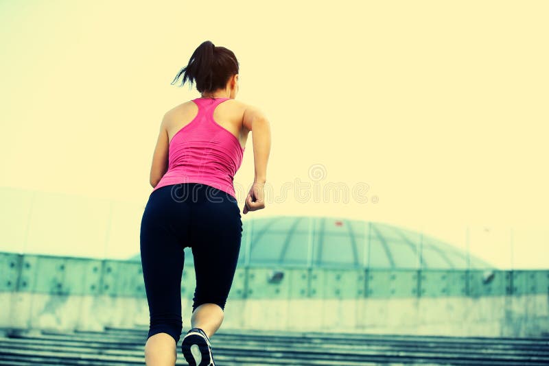 Woman running up on stone stairs