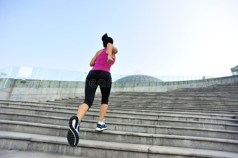 Woman running up on stone stairs