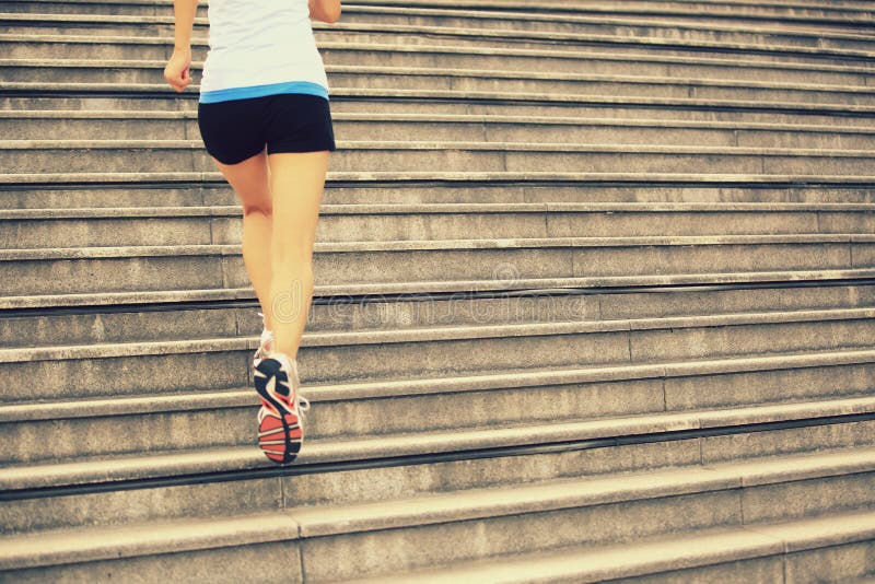 Woman running up on stone stairs