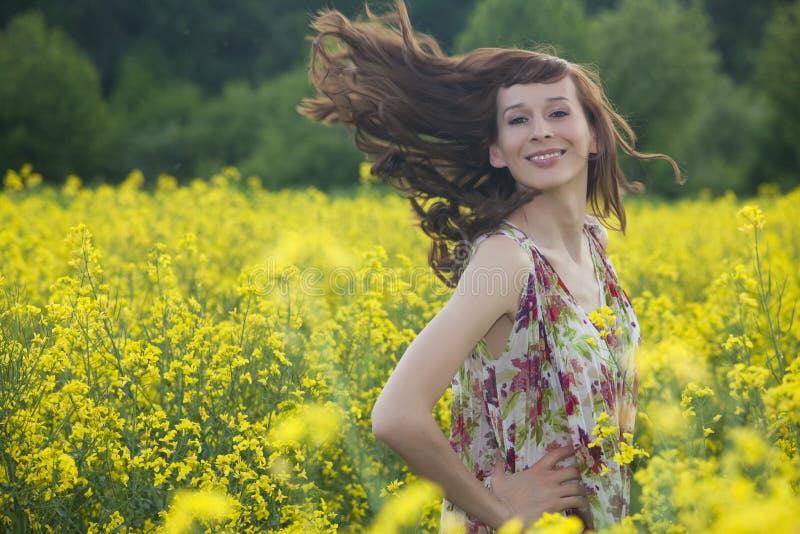 Woman running in yellow field