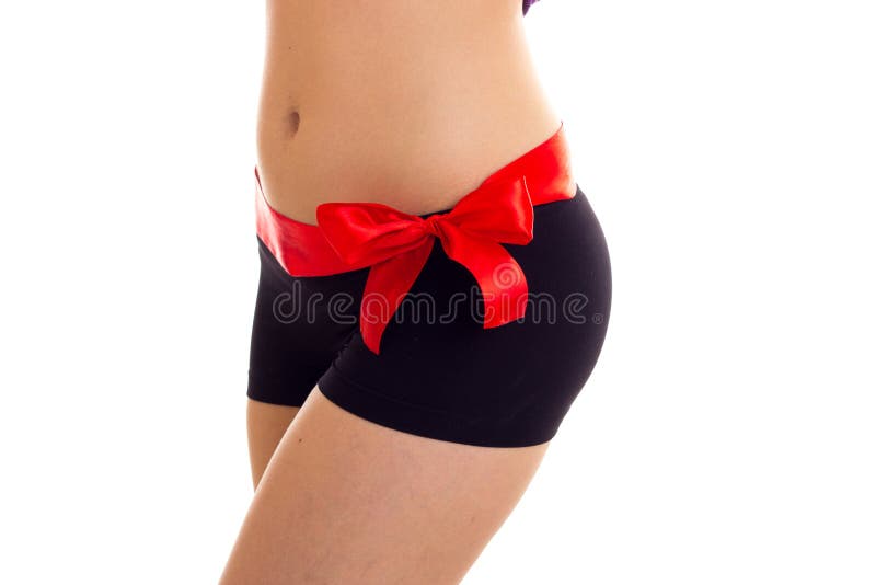 Woman`s buttocks with red bowtie