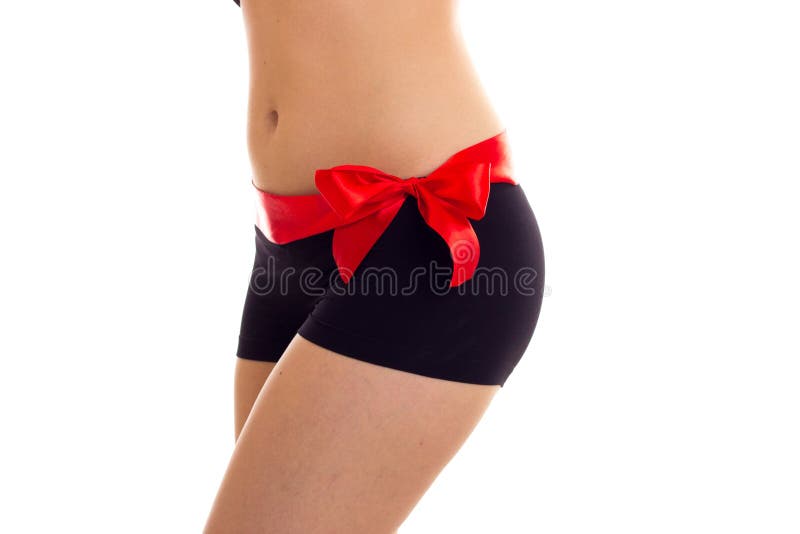 Woman`s buttocks with red bowtie