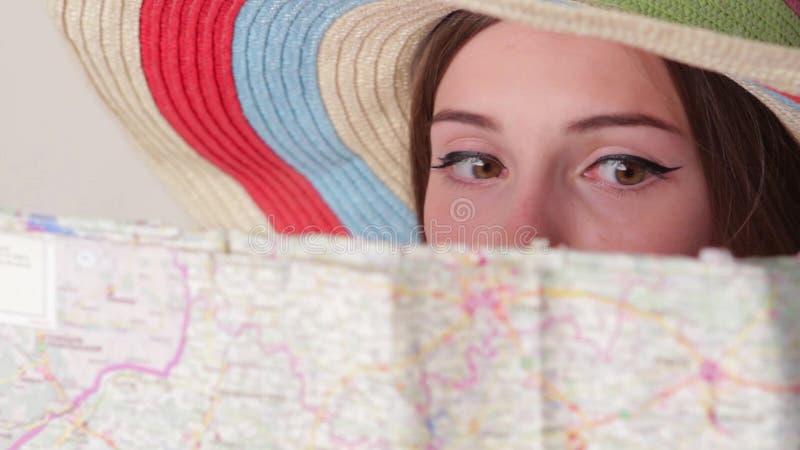 Woman's face behind a map.
