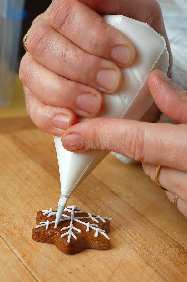 Woman s hand decorating Christmas sweets