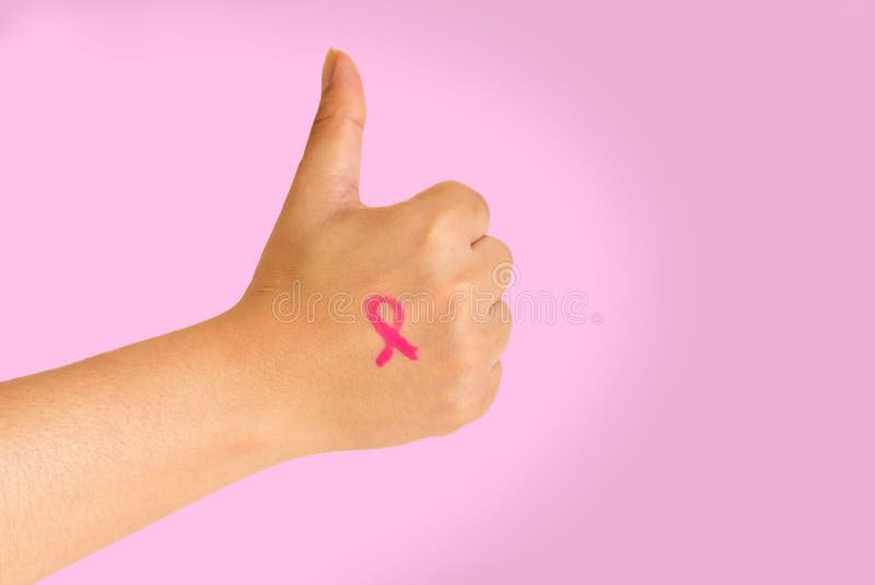 Woman`s hand making a positive gesture with the Breast Cancer Campaign symbol drawn in her skin over a pink background stock photo Woman`s hand making a positive gesture with the Breast Cancer Campaign symbol drawn in her skin over a pink background stock photo