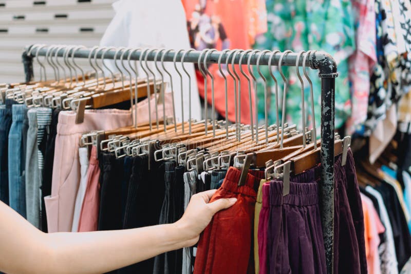 Woman`s Hand Shopping for Clothes at Clothes Store Stock Image - Image ...