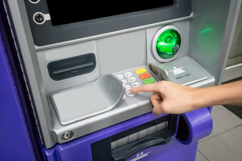 Woman`s hand using an ATM. Business woman using an atm machine stock image Woman`s hand using an ATM. Business woman using an atm machine stock image