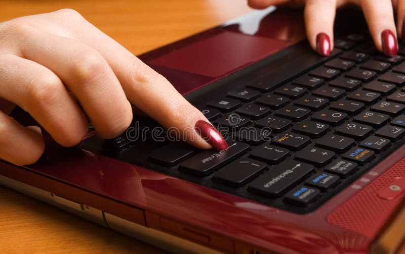 Woman s hand working on laptop