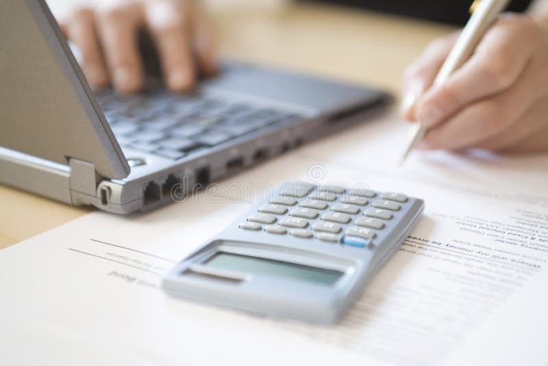 Woman's Hands Calculating Home Finances At Desk royalty free stock photo