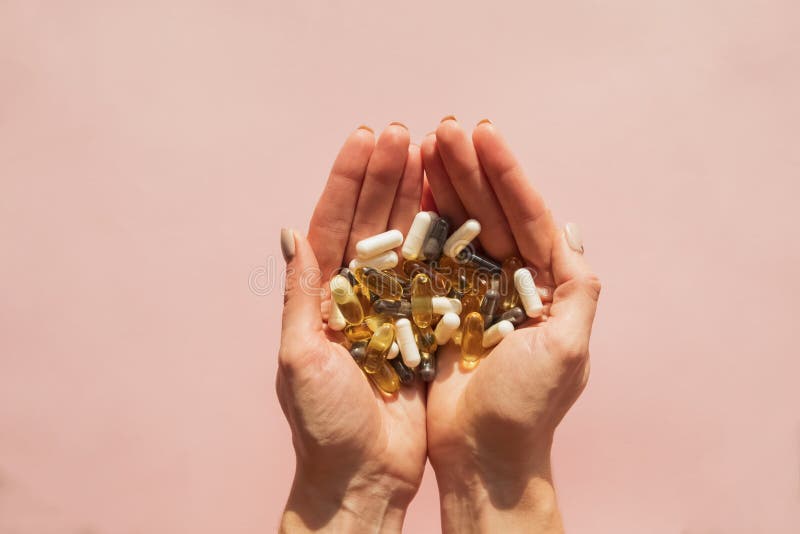 Woman`s hands holding a lot of different pills or dietic supplements royalty free stock images Woman`s hands holding a lot of different pills or dietic supplements royalty free stock images