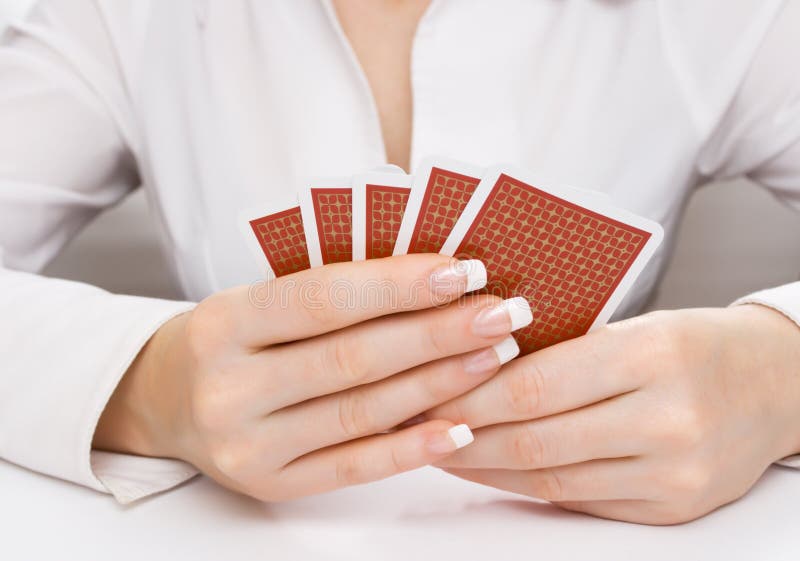 Woman s hands holding playing cards