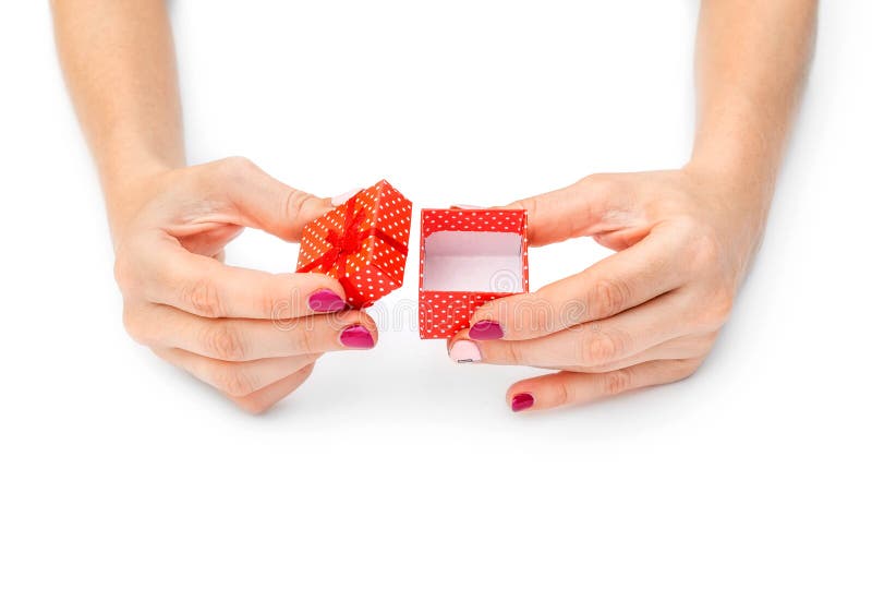 Woman's hands opening small gift box on white stock photography